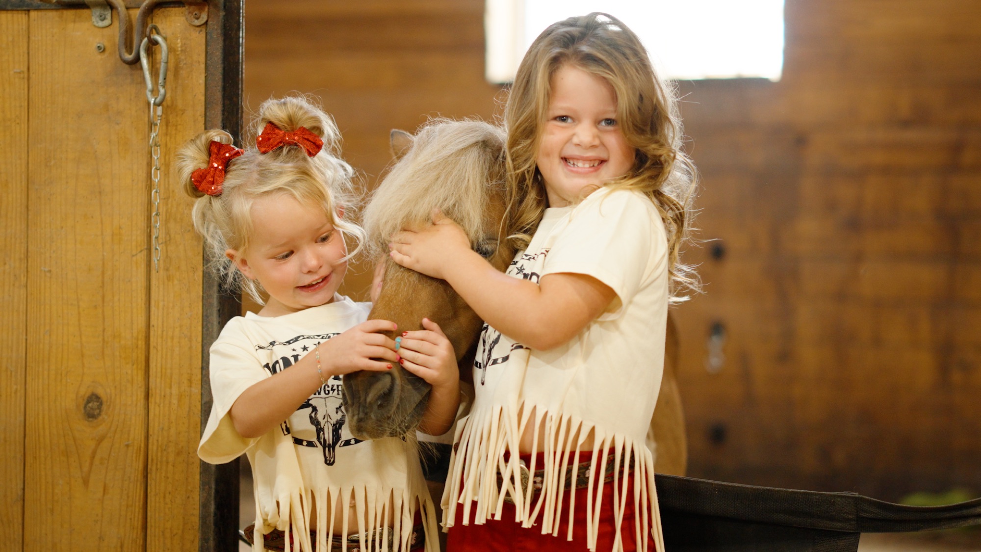 Two children with a miniature horse at The Stables